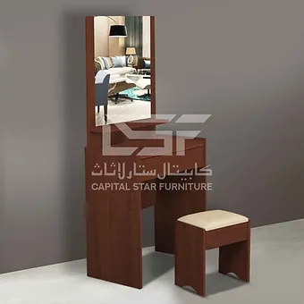 A sleek and modern dressing table featuring a minimalist design with clean lines, a large mirror, and organized accessories. The surface includes a few decorative items like candles and small plants, contributing to a stylish and functional space.